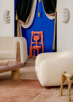 a living room filled with furniture and a blue wall