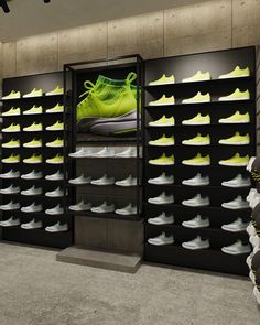 there is a large display of shoes in the shoe store with yellow and green colors