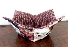 an origami bowl with two dogs on it