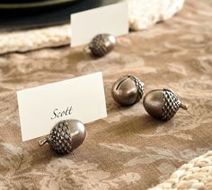 three metal knobs sitting on top of a table next to a white sign that says scott