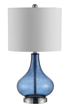 a blue glass lamp with a white shade on it's side and a silver base