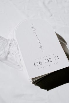 a white wedding card with the date on it