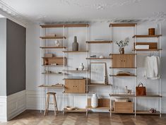 an empty room with shelves and stools