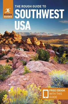 the rough guide to southwest usa with an orange and blue background, including mountains, bushes and