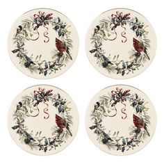 four plates with birds and holly wreaths on them