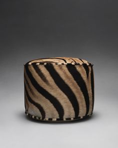 a zebra print hat on a gray background