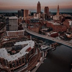 an aerial view of a city with tall buildings and a bridge in the foreground