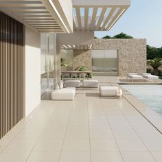 an outdoor living area with couches and tables next to a swimming pool