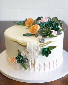 a white cake decorated with flowers and an animal's head