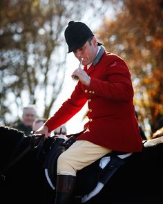 a man riding on the back of a black horse