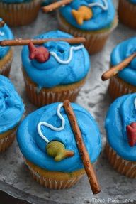 cupcakes with blue frosting and decorations on them