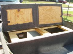 the back end of a truck with some wood in it