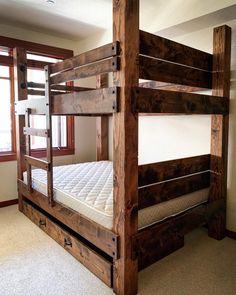 a wooden bunk bed in a room with carpeted flooring and windows on the side