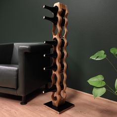 a wooden wine rack sitting next to a black chair