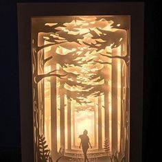 a paper cut out of a person walking through a forest