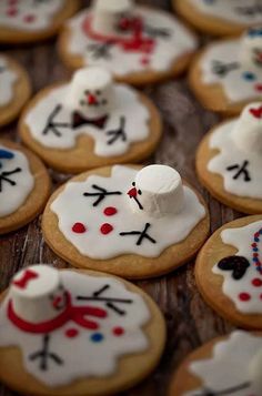 decorated cookies with frosting and icing are arranged on a table