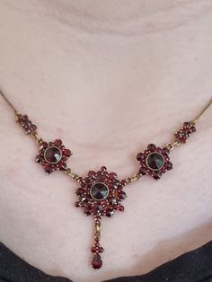 Exquisite 9ct Gold Garnet Set Necklace with foliate cluster and drop Era: Victorian Precious metal: Gold Gemstone: Garnet Weight: 9.9g Hallmarks: none present Length: approx. 40 cm or 19 inches. Condition: Excellent antique Beautiful example of a gorgeous antique Victorian gold and garnet cluster and drop necklace!  Set with luscious deep red faceted garnets,  and adorned by garnets along the gold chain and drop, this necklace is detailed enough to be very feminine, yet bold enough to be seen.  The garnets are well matched, with excellent colour and intensity and the three garnet clusters, with the stunning garnet drop detail speaks loudly to the design aesthetic of the Victorian era when this piece was made.  The chain itself has been tested for 9ct  fine yellow gold  and the secure 9ct g Festoon Necklace, Victorian Gold, Garnet Necklace, Set Necklace, Pretty Clothes, Floral Necklace, Stunning Necklace, Precious Metal, Drop Necklace