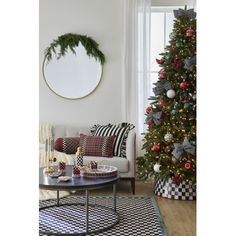 a living room with a christmas tree in the corner