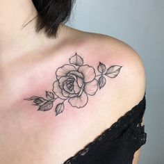 a woman's shoulder with a rose tattoo on the left side of her chest