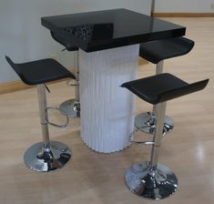 three stools and a table in a room