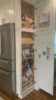 an open refrigerator freezer sitting inside of a kitchen