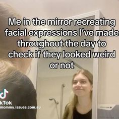 a woman is looking at her reflection in the mirror