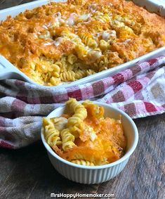 a casserole dish filled with macaroni and cheese next to a red and white checkered towel