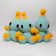 three crocheted stuffed animals sitting next to each other