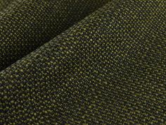 a close up shot of the fabric in green and brown colors, with small dots on it