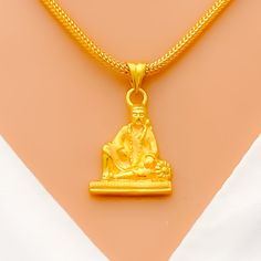 Make a statement with our Ethereal Sai Baba Pendant, crafted from 22k yellow gold and weighing 3.3 grams. With a delicate 1" length and intricate detailing, this pendant exudes a sense of grace and elegance. Elevate any outfit with this fashion-forward accessory that captures the essence of luxury and sophistication. PRODUCT DETAILS Gold Purity(karat): 22k Gold Weight(grams): 3.3 Item Finish: Yellow Gold Pendant Length: 1" Chain: Not Included PND22685W Gold Pendant Necklace For Rituals, Festive Gold Pendant Necklace, Spiritual Gold Necklace In 22k, 22k Gold Amulet Necklace, Spiritual 22k Gold Necklace, 22k Gold Spiritual Pendant Necklace, 22k Gold Necklaces For Puja, Gold-plated Temple Necklace For Gifts, Spiritual 22k Gold Pendant Necklace