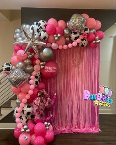 the balloon arch is decorated with pink, silver and black balloons for a cowgirl birthday party