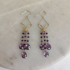 ITEM DESCRIPTION: >> The earrings are made from Solid 14K Yellow Gold. Gemstone used is absolutely natural and ethically sourced. >> Natural Amethyst in fancy shape with prong setting is studded on it with utmost precision. >> This is a minimalist design and is absolutely hassle-free and everyday jewelry. Gem: Purple Amethyst Gem weight: 14.67 carats Gold purity: 14K (58.33% approx.) Gold weight: 2.04 grams Gross weight: 4.99 grams The Gold purity is guaranteed and it comes with authentic 14K go Briolette Gemstone Chandelier Earrings As Gift, Purple Drop Chandelier Earrings As Gift, Amethyst Chandelier Earrings As Gift, Purple Teardrop Chandelier Earrings As Gift, Purple Earrings With Ear Wire For Anniversary, Purple Hook Earrings For Anniversary, Purple Anniversary Earrings With Ear Wire, Amethyst Chandelier Earrings For Pierced Ears As A Gift, Purple Chandelier Earrings With Ear Wire As A Gift