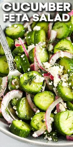 cucumber and feta salad in a silver bowl with a spoon on the side