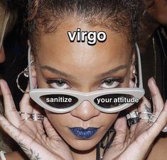 a woman wearing sunglasses with the words virgo written on her face in front of her