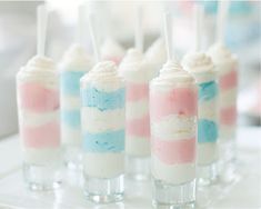 small desserts are lined up in glass cups