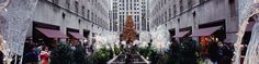 the interior of a shopping mall with christmas trees