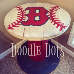 a baseball themed table with the letter b on it's base and ball painted on top