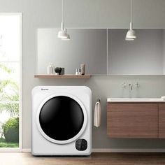 a white washer sitting on top of a wooden floor