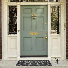 a green front door with two windows