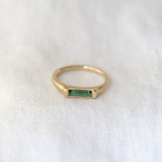 A slim rounded gold band with a signet like face made of a beautiful tourmaline bar - a sleek and modern way to add a pop of color to your stack! Details: Solid 14k Green Tourmaline baguette (8mm x 2mm) Tourmaline Baguette Ring, Minimalist Green Signet Ring, Modern 14k Gold Emerald Ring For Everyday, Baguette Ring, Bar Ring, Green Tourmaline, Gold Band, Gold Bands, Tourmaline