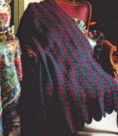 a woman sitting in a chair with a blanket on her lap