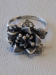 Vintage Sterling Silver Flower Ring Solid Sterling Silver flower ring with nice detailing. Ring fully hallmarked and will arrive gift boxed. * HALLMARKS 925 on back of flower. * MEASUREMENTS ring size 5 1/2, face of ring measures 17mm at widest part. * CONDITION In very good to excellent condition. Please use all pictures as part of item's description. * MATERIALS Sterling Silver. Silver Flower Ring, La Face, Sterling Silver Flowers, Flower Ring, Silver Flowers, Rings Statement, Sterling Silber, Vintage Sterling Silver, Women Rings