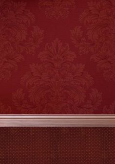 an empty room with red wallpaper and white trim