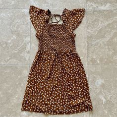 New Without Tags! Never Worn! Size Small Dee Elly Smocked Brown Floral Mini Dress With Flutter Sleeves. Ribbon Tie At Neck. 100% Rayon. Hand Wash. Perfect Fall Dress! Brown Smocked Back Sundress, Brown Sundress With Smocked Back, Casual Dress With Smocked Back And Ruffle Sleeve, Brown Smocked Bodice Dress For Daywear, Brown Dress With Smocked Bodice For Daywear, Brown Dress With Smocked Back For Daywear, Spring Non-stretch Smocked Back Dress, Summer Smocked Flutter Sleeve Dress For Daywear, Spring Casual Smocked Top With Flutter Sleeves