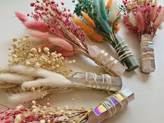 several different types of flowers and feathers on a table