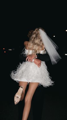 a bride and groom hugging in the dark