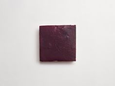 a square piece of wax paper sitting on top of a white surface