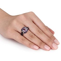 Brilliant in shades of purple, this gemstone and diamond fashion ring is an exceptional look for the February birthday girl. Created in sterling silver, the eye is drawn to the 10.0 x 8.0mm cushion-cut deep purple center stone. A frame of smaller rou Sterling Silver Halo Ring, Silver Halo Ring, Diamond Fashion Rings, Silver Wedding Rings, Halo Diamond Ring, Black Rhodium, Rings Wedding, Halo Ring, Diamond Fashion