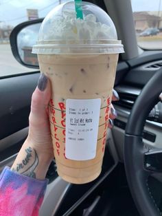 a woman holding up a cup of coffee in her hand with the caption that reads, venti iced while mocha made with sweet cream