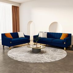 a living room with two blue couches and a round coffee table